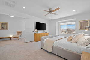 Bedroom with recessed lighting, visible vents, and light carpet
