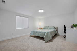 Bedroom featuring visible vents, carpet flooring, and baseboards