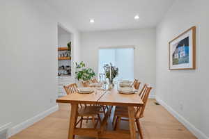 Dining area with recessed lighting, visible vents, baseboards, and light wood finished floors