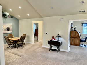 Dining space featuring carpet, visible vents, baseboards, recessed lighting, and vaulted ceiling