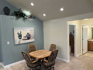 Dining area with recessed lighting, baseboards, and light carpet