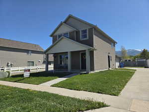 View of front of house with a porch, a mountain view, and a garage