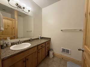 Bathroom with tile patterned flooring, toilet, vanity, and baseboards