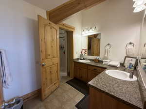Bathroom with double vanity and a shower stall