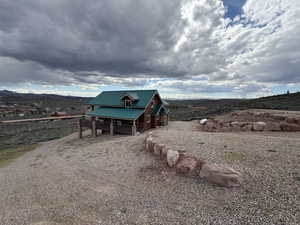 View of outdoor structure with a mountain view and gravel driveway
