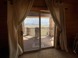 Doorway featuring carpet floors