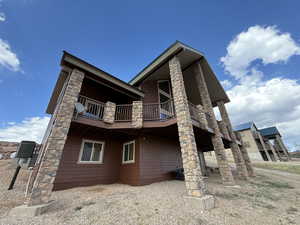Rear view of house with a balcony and central air condition unit