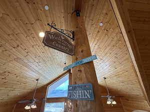 Detailed view of wood ceiling, ceiling fan, and wood walls