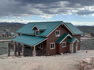 View of front facade with a standing seam roof, metal roof, and a mountain view