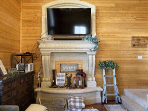 Living area with wood walls and wood finished floors
