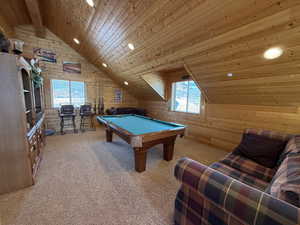 Recreation room featuring wooden ceiling, lofted ceiling, wooden walls, pool table, and recessed lighting