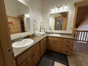 Full bathroom featuring tile patterned floors and double vanity