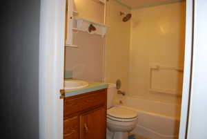 Full bath with shower / bathing tub combination, toilet, and vanity