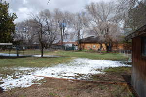 Yard covered in snow with fence