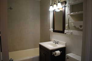 Bathroom featuring vanity, toilet, and tub / shower combination