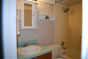 Full bath with bathing tub / shower combination, vanity, and toilet