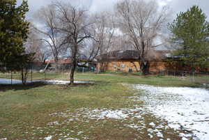 Yard layered in snow with fence