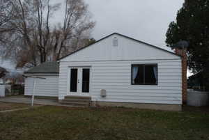 Back of house featuring a yard, entry steps, french doors, and board and batten siding