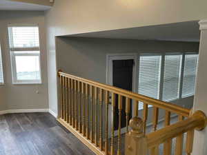 Corridor featuring baseboards and wood finished floors