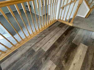 Kitchen and rail featuring wood finished floors