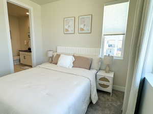 Upstairs loft Bedroom 3 with carpet flooring, ensuite bathroom, and baseboards
