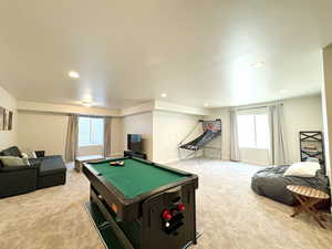 Recreation room featuring recessed lighting, baseboards, light colored carpet, and billiards