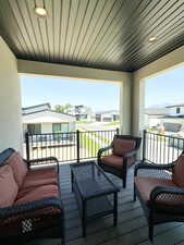Upper covered balcony featuring a mountain, residential view and an outdoor hangout area