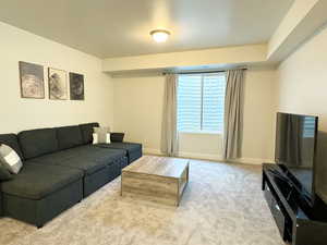 Living area with baseboards and carpet floors