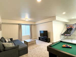 Carpeted living room with recessed lighting, pool table, and baseboards