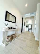 Hall featuring recessed lighting, baseboards, and wood finished floors