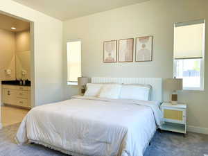 Master Bedroom with ensuite bath, bar, baseboards, and light carpet