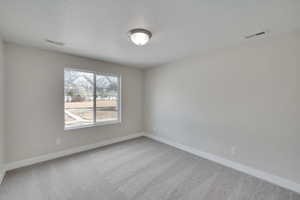 Unfurnished room with visible vents, carpet floors, and baseboards
