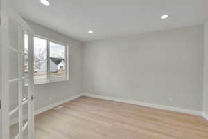 Empty room with recessed lighting, baseboards, visible vents, and light wood-type flooring