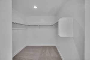 Spacious closet with carpet flooring