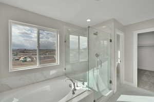 Bathroom featuring a marble finish shower, marble finish floor, baseboards, and a garden tub