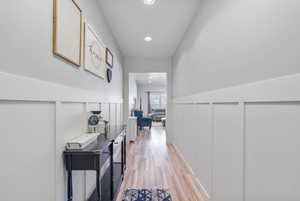 Entry hallway with recessed lighting and a decorative wall