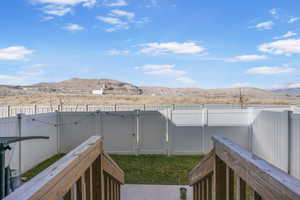View of yard featuring a gate, a fenced backyard, and a mountain view