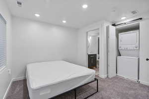 Basement bedroom with attached laundry and bathroom. Stacking washer and dryer included.