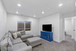 Basement living room with ample recessed lighting