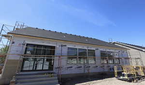 Back of house with roof with shingles