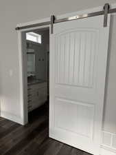 Master suite with barn door to full bath with shower stall