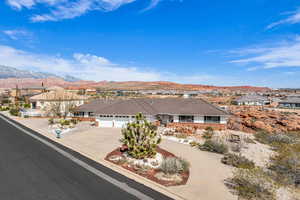 Ranch-style home with driveway, a mountain view, a residential view, a garage, and a tiled roof