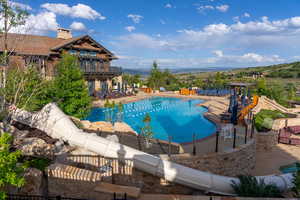 Community pool with a patio area and a mountain view