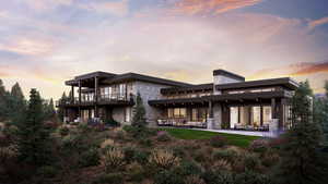 Back of property at dusk featuring stone siding and a patio