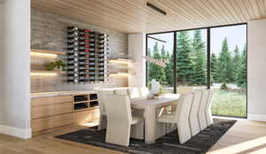 Wine room featuring wooden ceiling, light wood-style flooring, and floor to ceiling windows