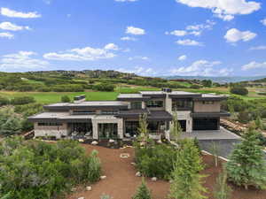 View of building exterior featuring asphalt driveway, a garage, and a mountain view