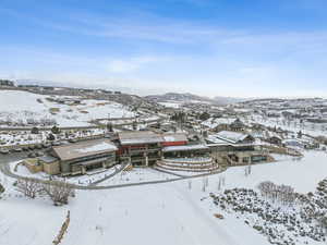 Snowy aerial view featuring a mountain view and a residential view