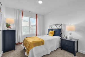 Bedroom featuring visible vents, baseboards, and light colored carpet