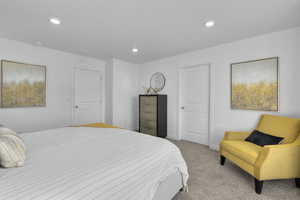 Bedroom with recessed lighting, light colored carpet, and baseboards