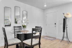Dining space with baseboards and light wood finished floors
